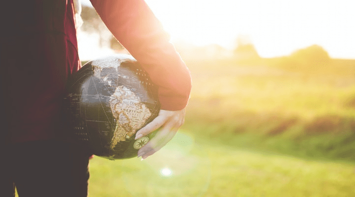 small globe held in hand